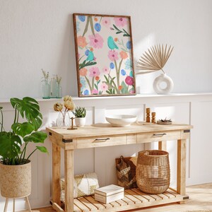Pretty art print featuring three abstract blue birds perching on wildflowers and foliage, on a cream background.