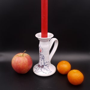 Candle holder with ceramic handle candle flame and holly