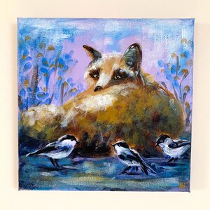 May include: Square canvas painting featuring a fox and three small birds. The fox is rendered in shades of brown and gold, with a watchful gaze. The birds are black and white. The background has blue and purple floral elements.