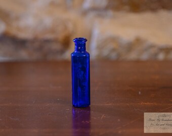 Vintage Colbalt Blue Hexagonal Bottle, in the style of a pharmaceutical poison bottle