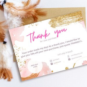 May include: A pink and gold thank you card with a watercolour background and gold glitter. The card reads "Thank you for your purchase" and "Your order made my day! As a thank you, I would like to give you 10% off your next purchase, just quote THANKS11." It also includes space to add a logo and social media handles.
