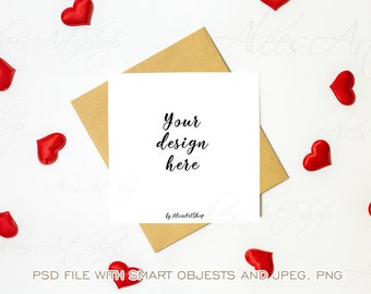 Puede incluir: Una tarjeta blanca con el texto "Your design here" y las palabras "by AleesArtShop" impresas en ella. La tarjeta está sobre un sobre marrón y rodeada de corazones rojos.
