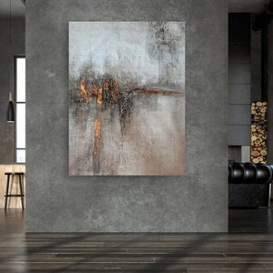 May include: Abstract painting with shades of gray, brown, and gold. The painting has a textured surface and a horizontal line of gold paint across the middle.