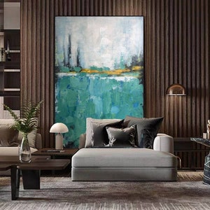 May include: Abstract painting with a green, blue, and yellow color scheme. The painting is on a canvas and is hanging on a wall in a living room.