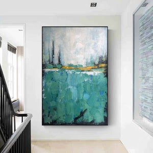 May include: Abstract painting with a green and white color scheme. The painting features a horizontal band of gold paint separating the green and white sections. The green section is made up of thick, textured brushstrokes.