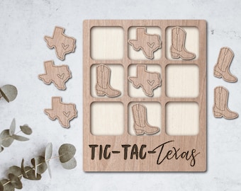 May include: Wooden Tic-Tac-Toe game with a Texas theme. The game board has nine squares with images of cowboy boots and the state of Texas with a heart in the center. The game pieces are also made of wood and feature the same images.