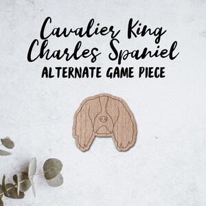May include: A wooden cutout of a Cavalier King Charles Spaniel, with the text "Cavalier King Charles Spaniel Alternate Game Piece" above it.