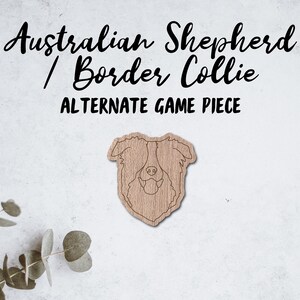 May include: A wooden game piece in the shape of an Australian Shepherd / Border Collie dog head. The text "Australian Shepherd / Border Collie" and "ALTERNATE GAME PIECE" are above the dog image. The piece is light brown with a wood grain texture.