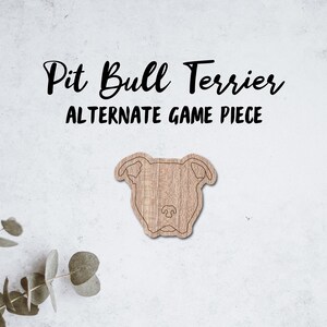 Puede incluir: Un recorte de madera de un Pit Bull Terrier, con el texto "Pit Bull Terrier Alternate Game Piece" encima.