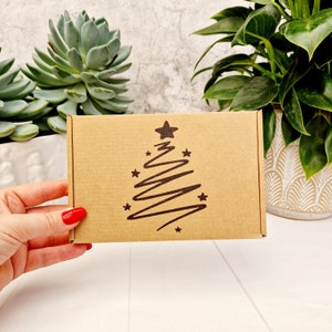 Joyeux Noël et bonne année, boîte cadeau vide kraft estampée à la main. Emballage recyclable respectueux de l'environnement. Boîte en carton unique PIP C6/A6