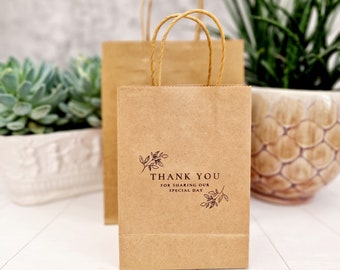 May include: Two brown paper gift bags with handles. The smaller bag has the text "Thank You for sharing our special day" printed on it.