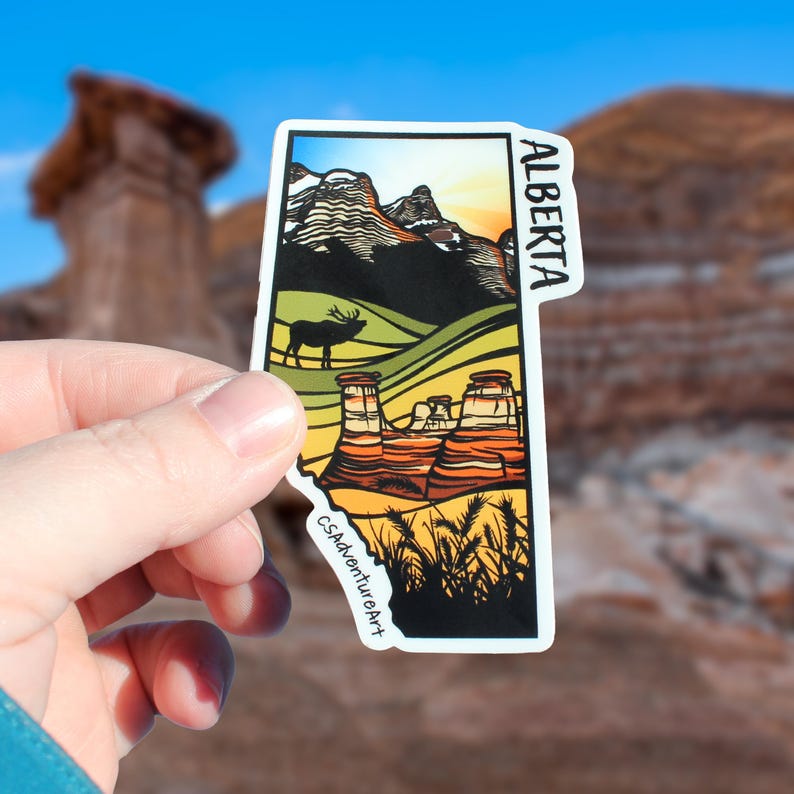 Alberta, Canada sticker held in models hand for scale