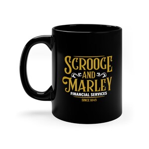 May include: Black ceramic mug with a gold design that reads "Scrooge and Marley Financial Services Since 1843".