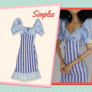 May include: A doll dress featuring a light blue bodice with short puff sleeves and a sweetheart neckline. The skirt section has a vertical blue and white striped pattern with a light blue ruffled hem. The word Simples is printed in red script.