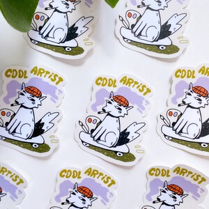 Puede incluir: Nueve pegatinas con un lobo de dibujos animados que lleva un sombrero rojo, sostiene un cigarrillo y un pincel, y monta en patinete. Las pegatinas tienen un fondo morado y blanco con el texto "COOL ARTIST" en amarillo.