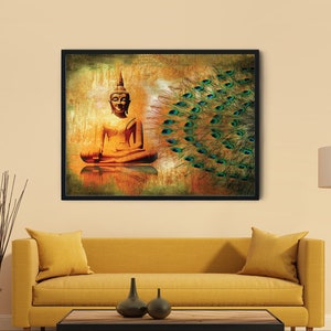 May include: A rectangular wall art print in a black frame featuring a golden Buddha figure in a seated meditation pose on the left, contrasted by a vibrant, detailed peacock feather fan pattern on the right, set against a warm, textured background.