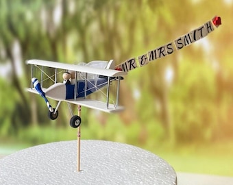 Wedding Airplane Cake Topper. With custom Mr. and Mrs. banner and cute figurines of the bride and groom on the plane. Travel, Pilot Wedding