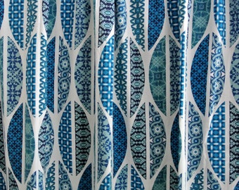 May include: A white fabric with a repeating pattern of blue and teal leaf shapes. The leaves are filled with intricate geometric designs.