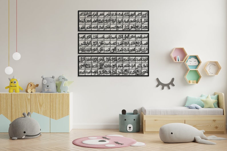 May include: Three black metal wall art pieces with Arabic calligraphy in a white room with a wooden shelf and a bed with pillows and a gray whale stuffed animal.