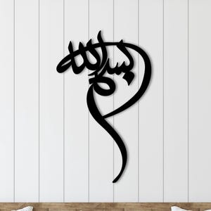 Op de afbeelding: Zwarte metalen wandkunst met de Arabische kalligrafie voor "Bismillah", wat "In de naam van Allah" betekent.