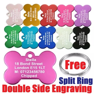 May include: A selection of bone-shaped pet ID tags in multiple colours, such as pink, red, and green. Each tag has engraved text with contact details and the word "Chipped". A free split ring is also included.