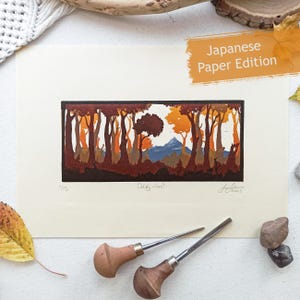 May include: A rectangular art print on cream paper featuring a forest landscape with dark brown tree silhouettes, orange and yellow foliage, and a blue mountain peak in the distance. The print includes the text "Japanese Paper Edition" and "1/3".
