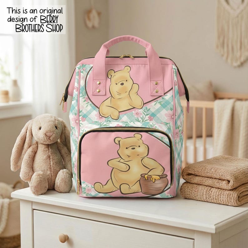 May include: A pink and teal plaid backpack featuring Winnie the Pooh illustrations on the front pockets. The bag has pink top handles, gold-tone zippers, and a floral pattern. Text in the corner reads: This is an original design of BERRY BROTHERS SHOP.