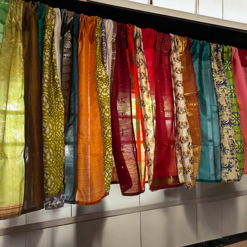 May include: A colorful curtain made of many different fabrics, with a variety of patterns and textures. The curtain is made of a mix of silk, cotton, and linen fabrics. The curtain is a beautiful and unique way to add a touch of color and style to any room.