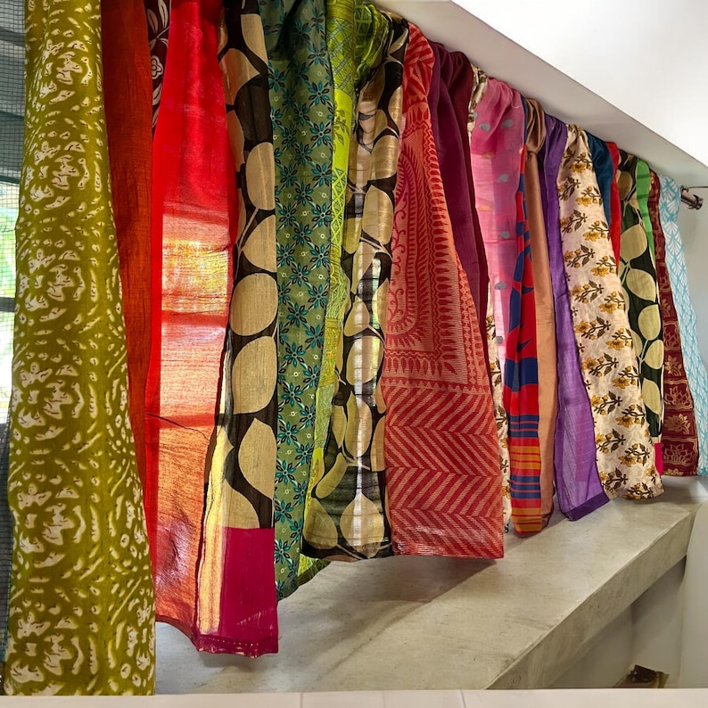 May include: A set of colorful fabric curtains with various patterns, including floral, geometric, and paisley designs. The curtains are made of a soft, flowing material and are perfect for adding a touch of bohemian style to any room.