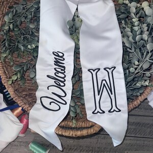 embroidery welcome with inital wreath sash