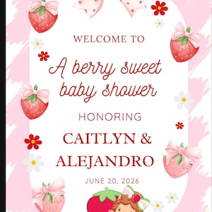 May include: A pink baby shower sign with strawberry and bow illustrations. The text reads "Welcome to A berry sweet baby shower honoring Caitlyn & Alejandro June 20, 2026."