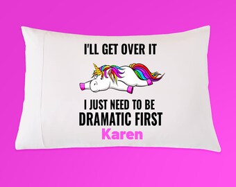 May include: White pillowcase with the text "I'll get over it, I just need to be dramatic first Karen" and a cartoon unicorn with a rainbow mane and tail. The pillowcase is on a pink background.