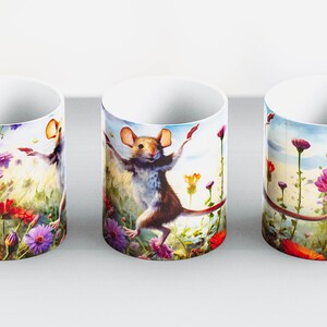 May include: White ceramic mug featuring a whimsical illustration of a mouse dancing in a field of colorful flowers. The design includes red, purple, and pink flowers, with a blue sky background. The mug has a white handle.