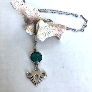 Silver hand-carved pendant in Indian motif with turquoise accent necklace
