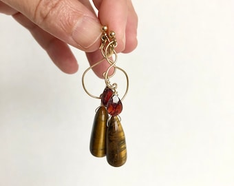 Hand-shaped gold filled wire earrings with large tiger's eye and small garnet drops
