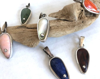 Handmade teardrop pendants in a variety of natural stones and shells set in sterling silver