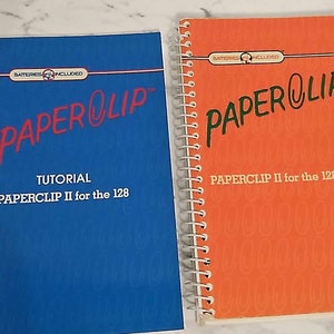 May include: Two manuals for the Paperclip II computer program. The blue manual is titled "TUTORIAL PAPERCLIP II for the 128" and the orange manual is titled "PAPERCLIP II for the 128".