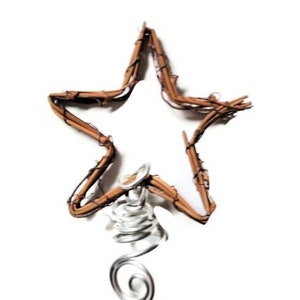 May include: A brown twig star Christmas tree topper with a silver wire spiral base.