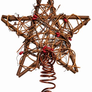 May include: A star-shaped tree topper constructed from brown twigs and thin, winding vines. The star is accented with small, smooth, bright red berries tucked into the branches. A coiled, metallic copper-colored wire base extends downward.