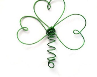 Peut inclure: Un trèfle en fil de fer vert avec une tige en spirale. Le trèfle est fait de fil de fer et a la forme d'un trèfle à trois feuilles.