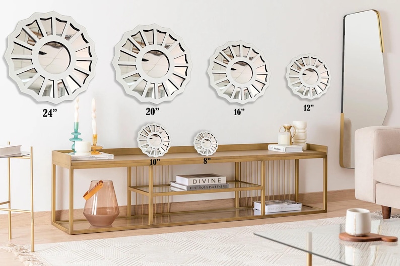 May include: A set of six white, decorative, round mirrors with a sunburst design. The mirrors are arranged in a row on a gold metal shelf with two shelves. The mirrors are 24 inches, 20 inches, 16 inches, 12 inches, 10 inches, and 8 inches in diameter.