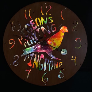 Pigeons Playing Ping Pong illuminated clock