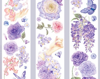 Puede incluir: Cinta washi decorativa con ilustraciones de acuarela de rosas moradas, lilas, mariposas y gemas. La cinta tiene un fondo blanco y un diseño vertical, ideal para álbumes de recortes y manualidades.