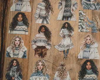 May include: A selection of sticker cutouts depicting illustrations of women in winter clothing. The stickers show women wearing sweaters, coats, and dresses with winter-themed patterns. The colour scheme includes blues, whites, and browns, creating a seasonal aesthetic.