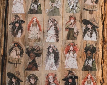 May include: A collection of transparent stickers featuring illustrations of women with long hair, floral crowns, and dresses. The color palette includes soft greens, reds, and browns, with a vintage aesthetic. The stickers are arranged on a wooden surface.