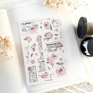 May include: A rectangular sticker sheet featuring various illustrations of soft pink peonies, green leaves, and vintage-style black typography including text like City Furnishing, Wholesale Only, and various numerical columns on a white background.