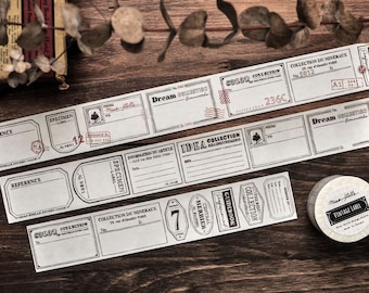 May include: A collection of vintage-style paper labels and decorative tape rolls. The labels feature various rectangular and oval designs with text like "Dream Collection" and "Vintage Label". The color scheme is primarily black and white.