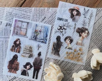 May include: Two sheets of decorative stickers featuring watercolor illustrations. One sheet has images of women, a window, and a stack of books. The other sheet has images of women, flowers, and the text "SIMPLE LIFE".