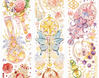 May include: Decorative washi tape featuring whimsical illustrations. Designs include celestial elements, teddy bears, butterflies, and keys, in a palette of gold, pink, and purple. The tape is adorned with stars, moons, and pearls.