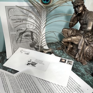 May include: A vintage book titled "Remarkable Story" by Author Worth Remembering, with a peacock feather and a bronze statue of a person sitting on a chair. The book is on a white envelope with a handwritten address.
